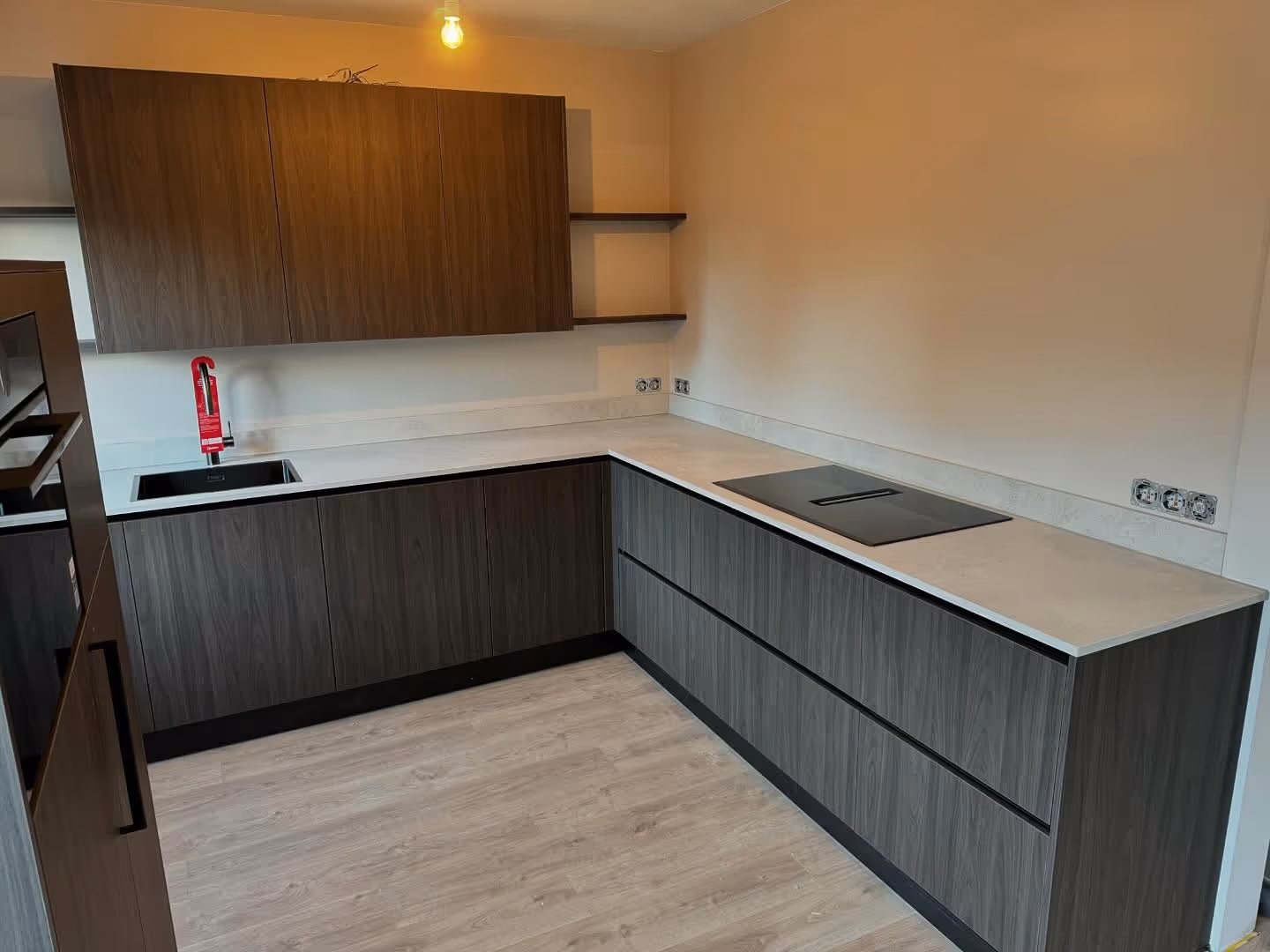 A cozy reading nook with a yellow armchair, a floor lamp, and a framed abstract print.